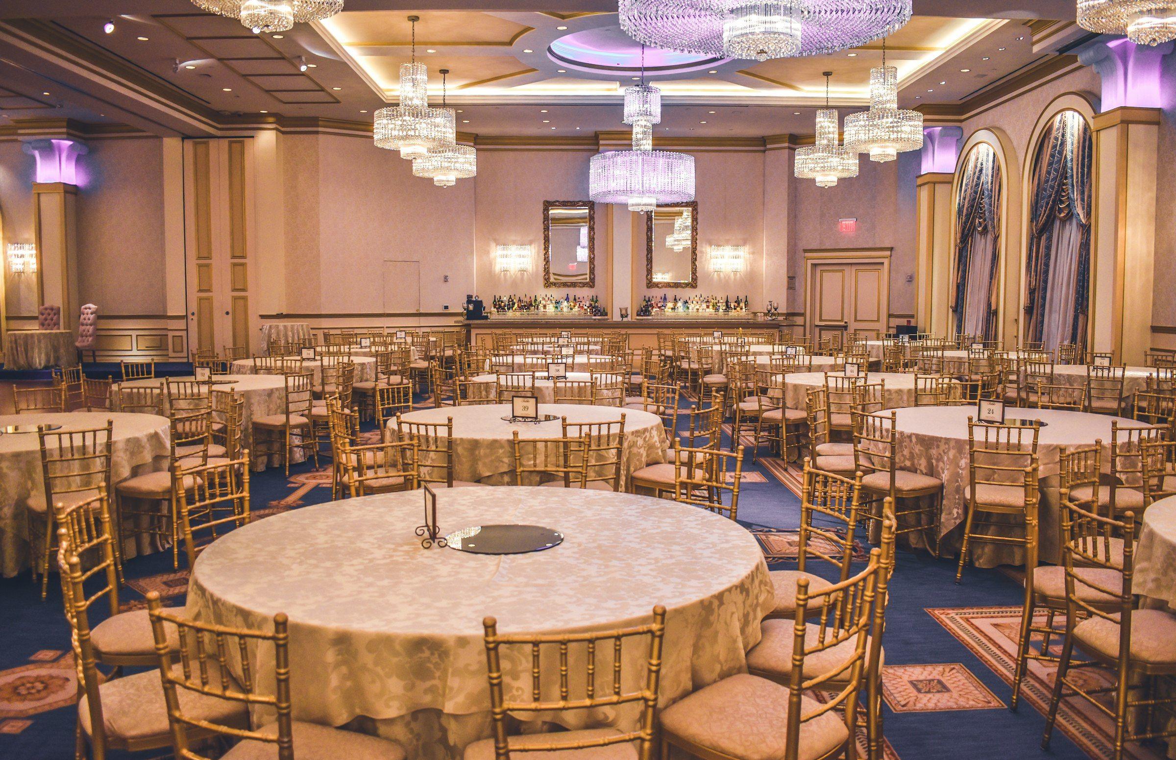 A grand ballroom dressed for a luxury wedding